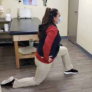 woman demonstrating hip flexor stretch