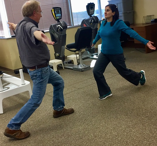 therapist and patient doing lunges