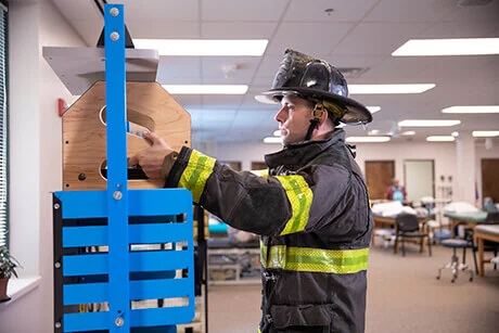 A firefighter doing physical therapy exercises.