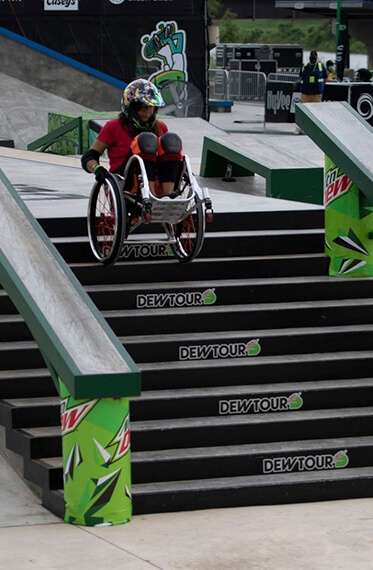 Tracie mid going down stairs on her wheelchair